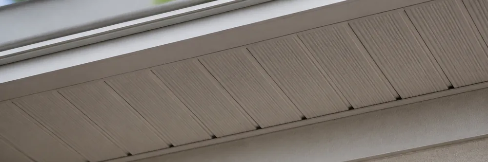 Close-up of clean vented soffit panels under a roofline